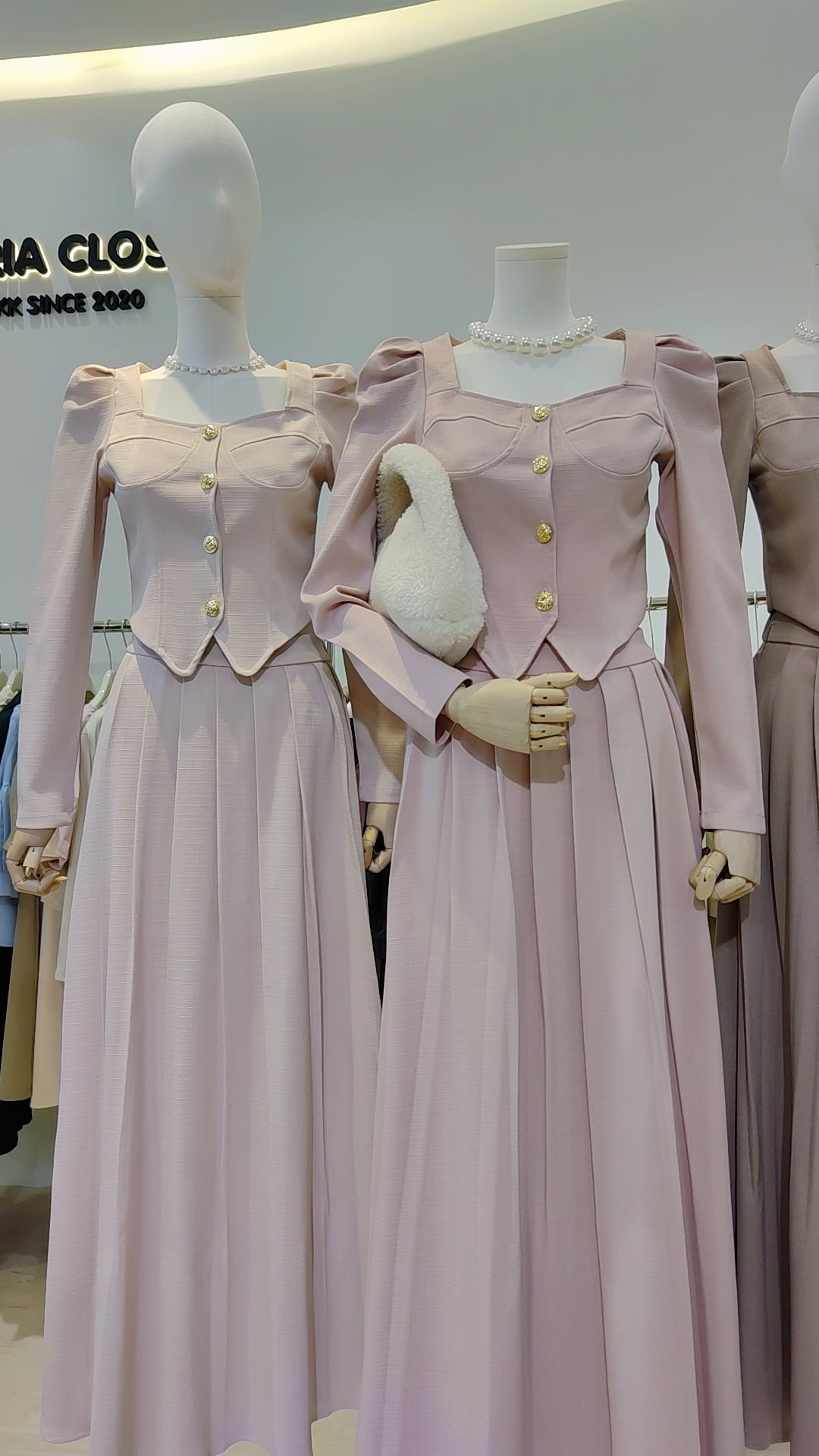 The "Flowy Tweed" Co-ord Set in soft pink with puffed sleeves and gold buttons on mannequin displays.