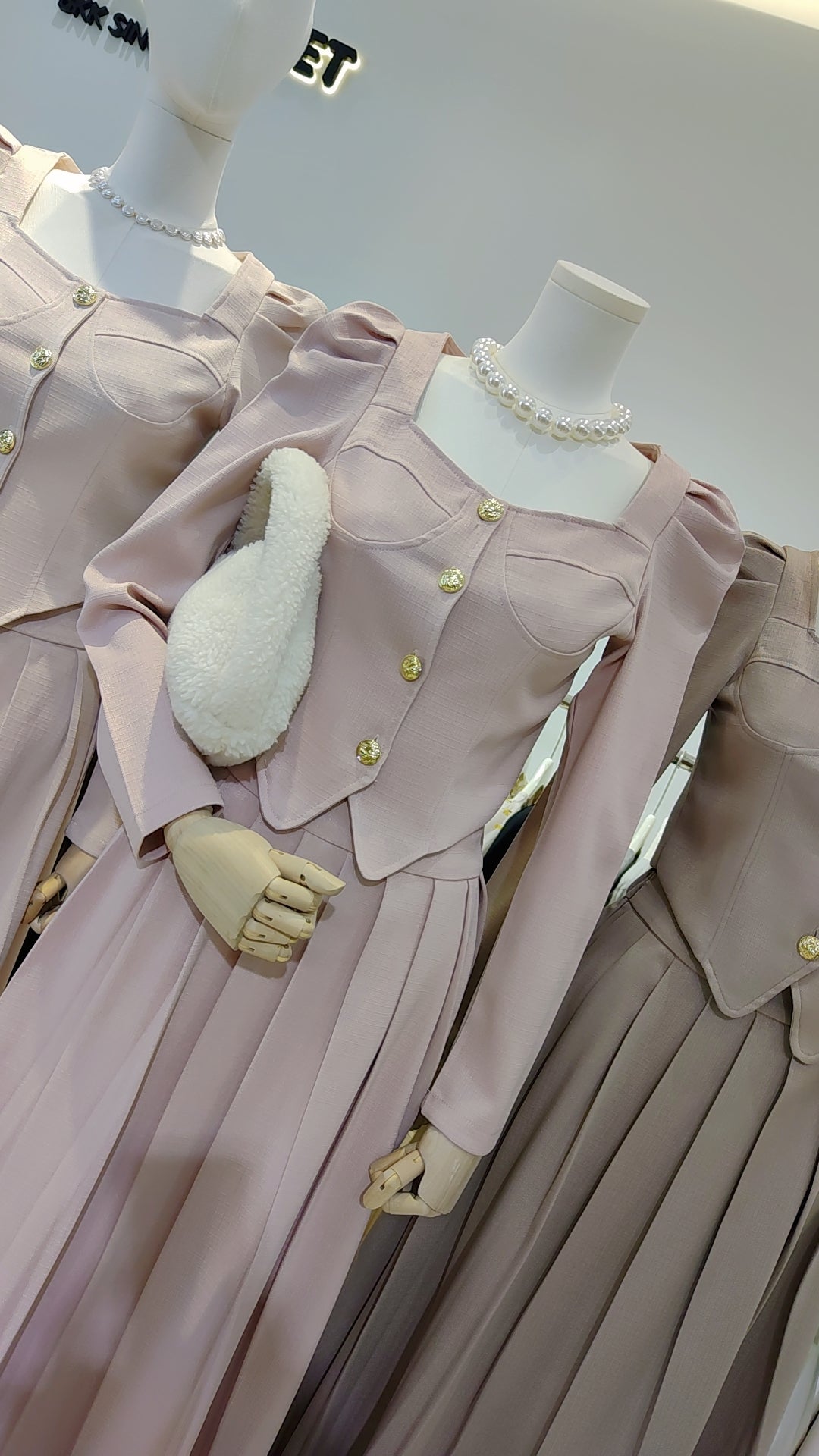 The "Flowy Tweed" Co-ord Set displayed on mannequins with pearl necklaces and soft pastel pleated skirts.