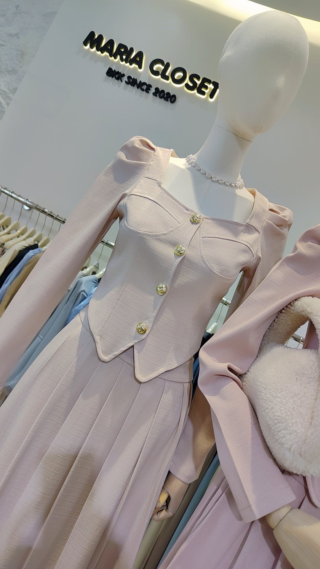 The "Flowy Tweed" Co-ord Set on a mannequin featuring a fitted long-sleeve top and pleated skirt.