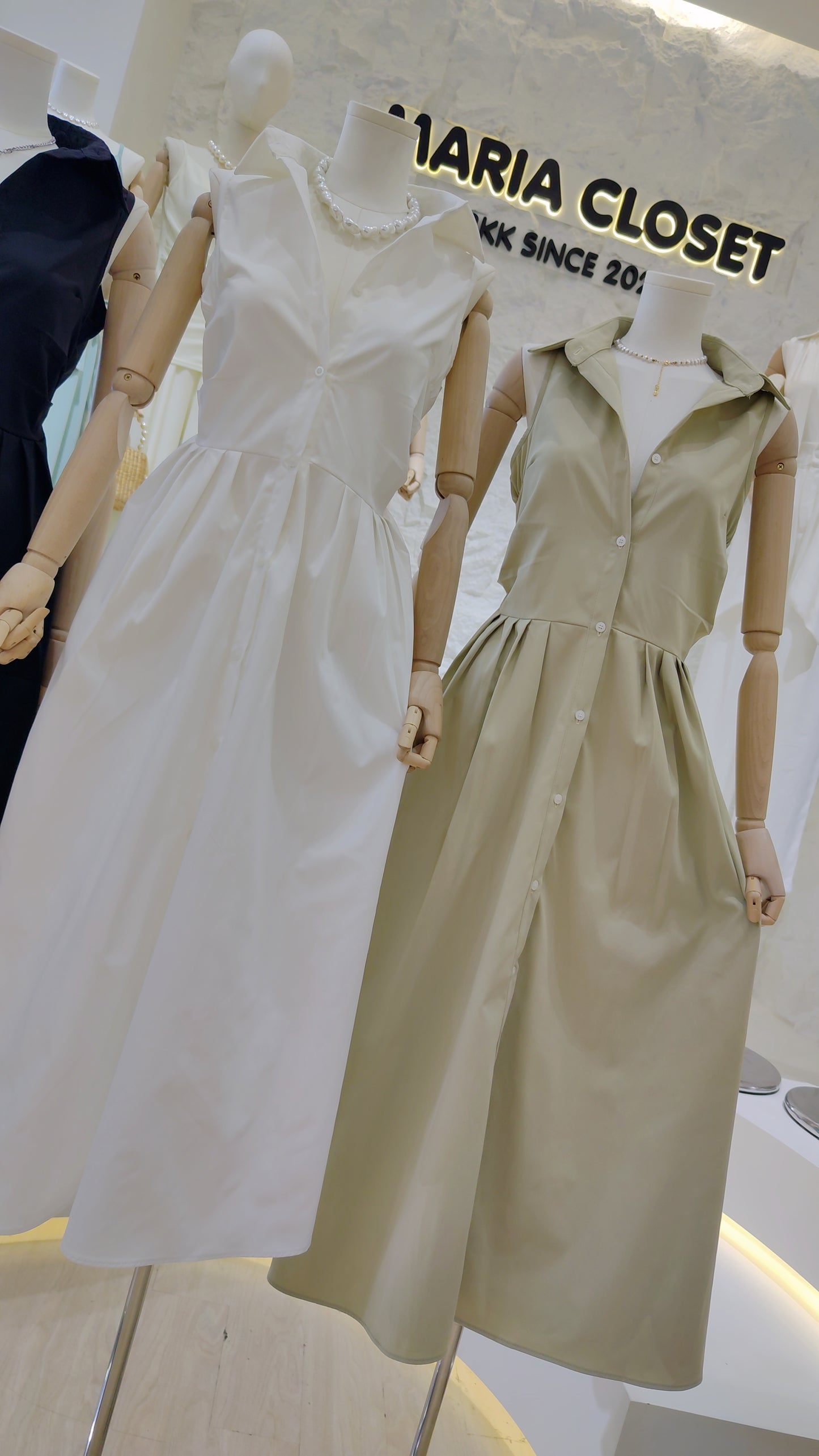 The "Everyday" Sleeveless Shirt Dress in white and beige, featuring a classic collar and button-front design.