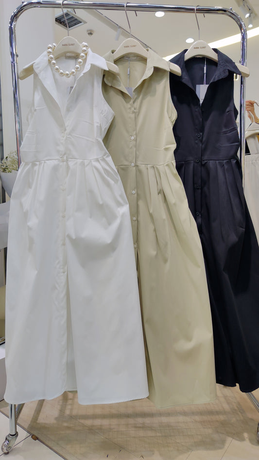 The "Everyday" Sleeveless Shirt Dress in white, beige, and black with button-front and collar details on hangers.