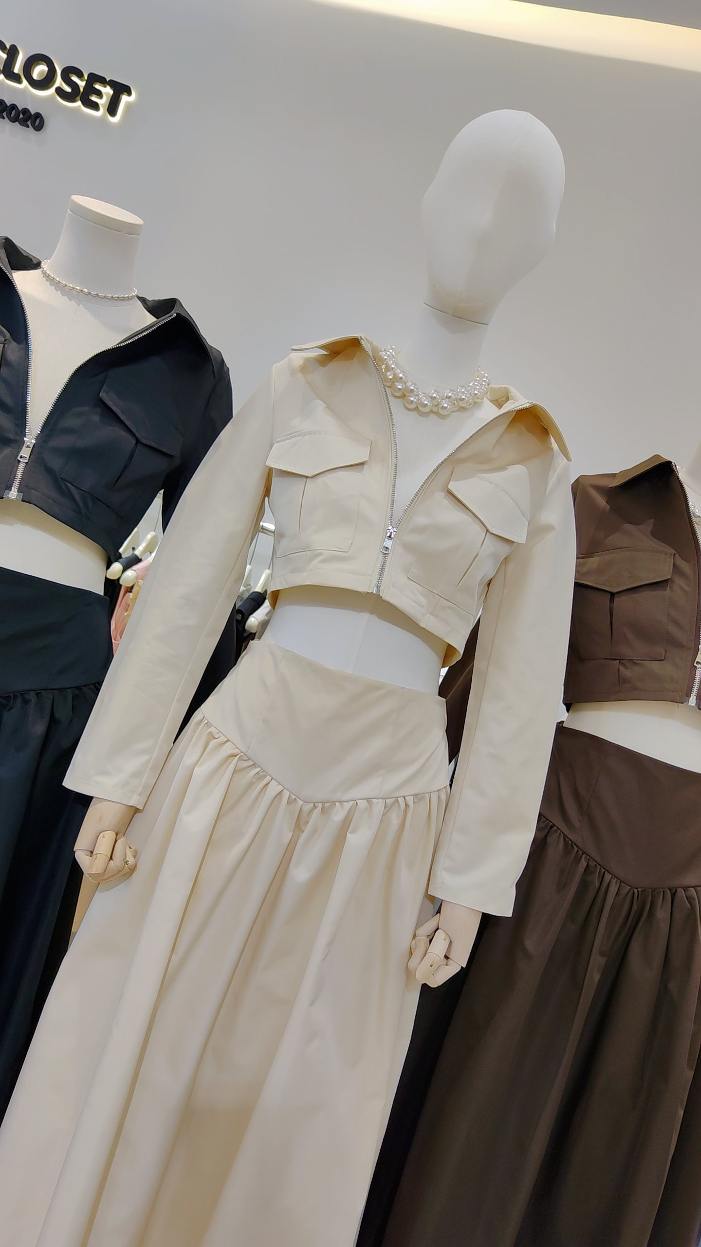 The "Classic Vest" Co-ord Set in beige featuring a zip-front vest and matching long skirt on a mannequin.