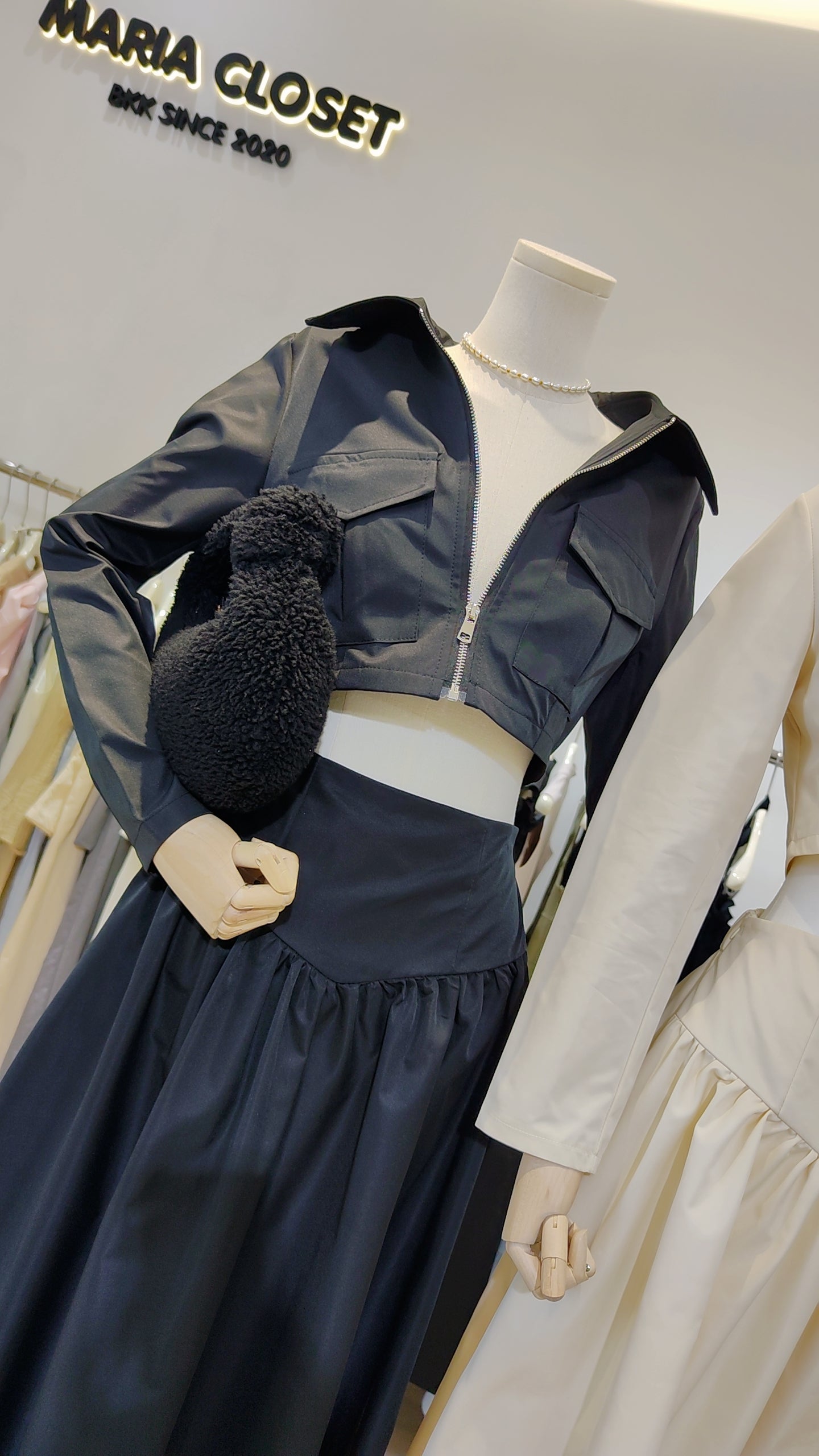 The "Classic Vest" Co-ord Set featuring a cropped zip-front vest and matching elegant long skirt in black fabric.