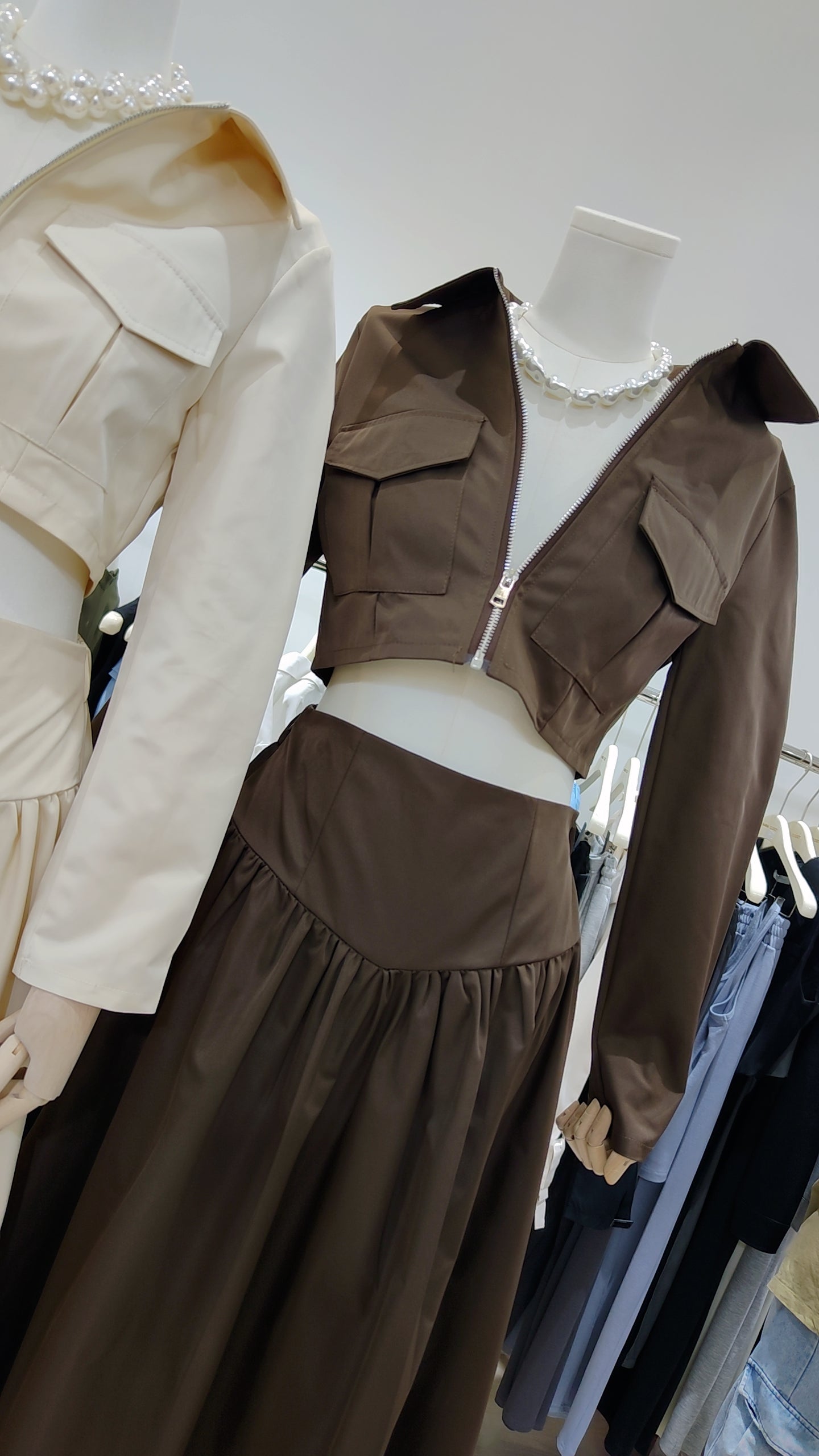 The "Classic Vest" Co-ord Set in brown featuring a zip-front vest and matching elegant long skirt on a mannequin.