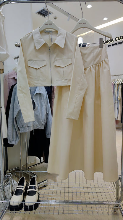 The "Classic Vest" Co-ord Set in cream with zip-front vest and matching long skirt on hanger.