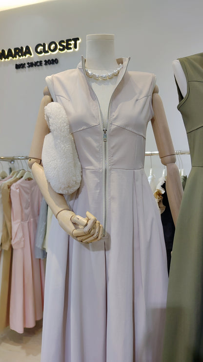 Mannequin wearing The Urban Zip-Front Maxi Dress in light color with front zipper and sleeveless design.