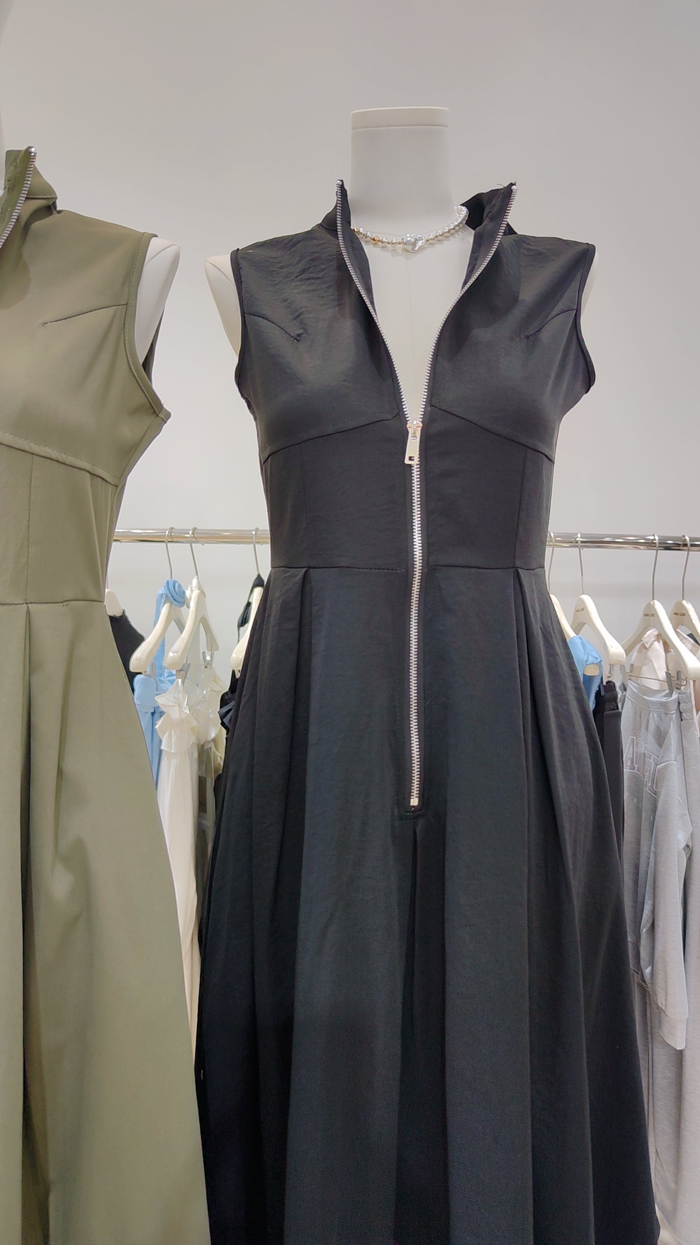 Black sleeveless Urban Zip-Front Maxi Dress with a bold front zipper and structured relaxed silhouette on a mannequin.