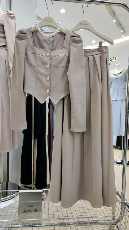 The "Flowy Tweed" Co-ord Set features a beige buttoned puff-sleeve top and matching long skirt with a flexible waist.