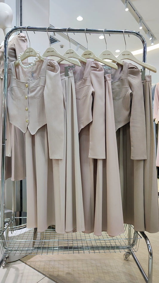 The "Flowy Tweed" Co-ord Set displayed on hangers, featuring a fitted top and long flowing skirt in soft neutral tones.