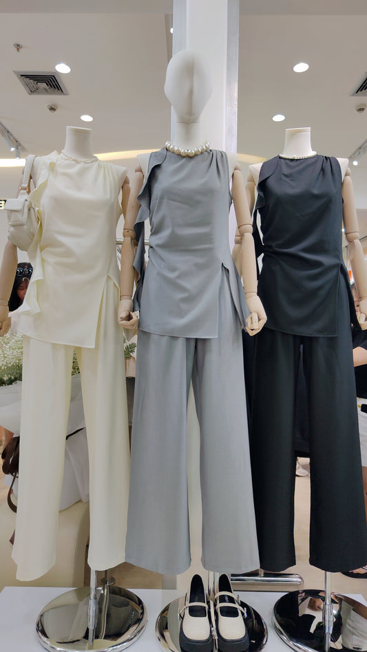 Three mannequins wearing the Flowy Tunic Two-Piece Set in cream, gray, and black colors.