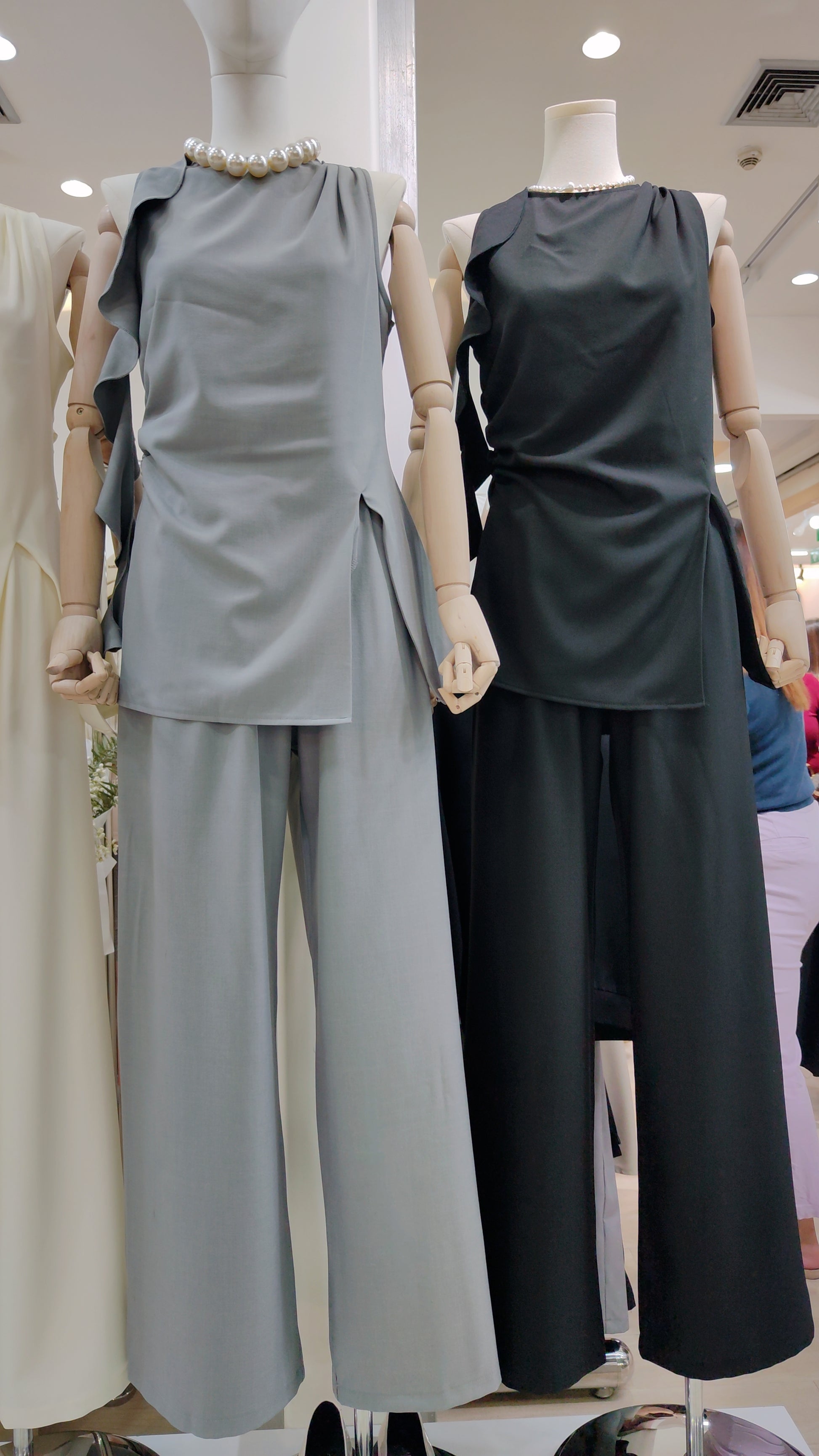 Two mannequins dressed in gray and black Flowy Tunic Two-Piece Set with sleeveless tops and wide-leg pants.