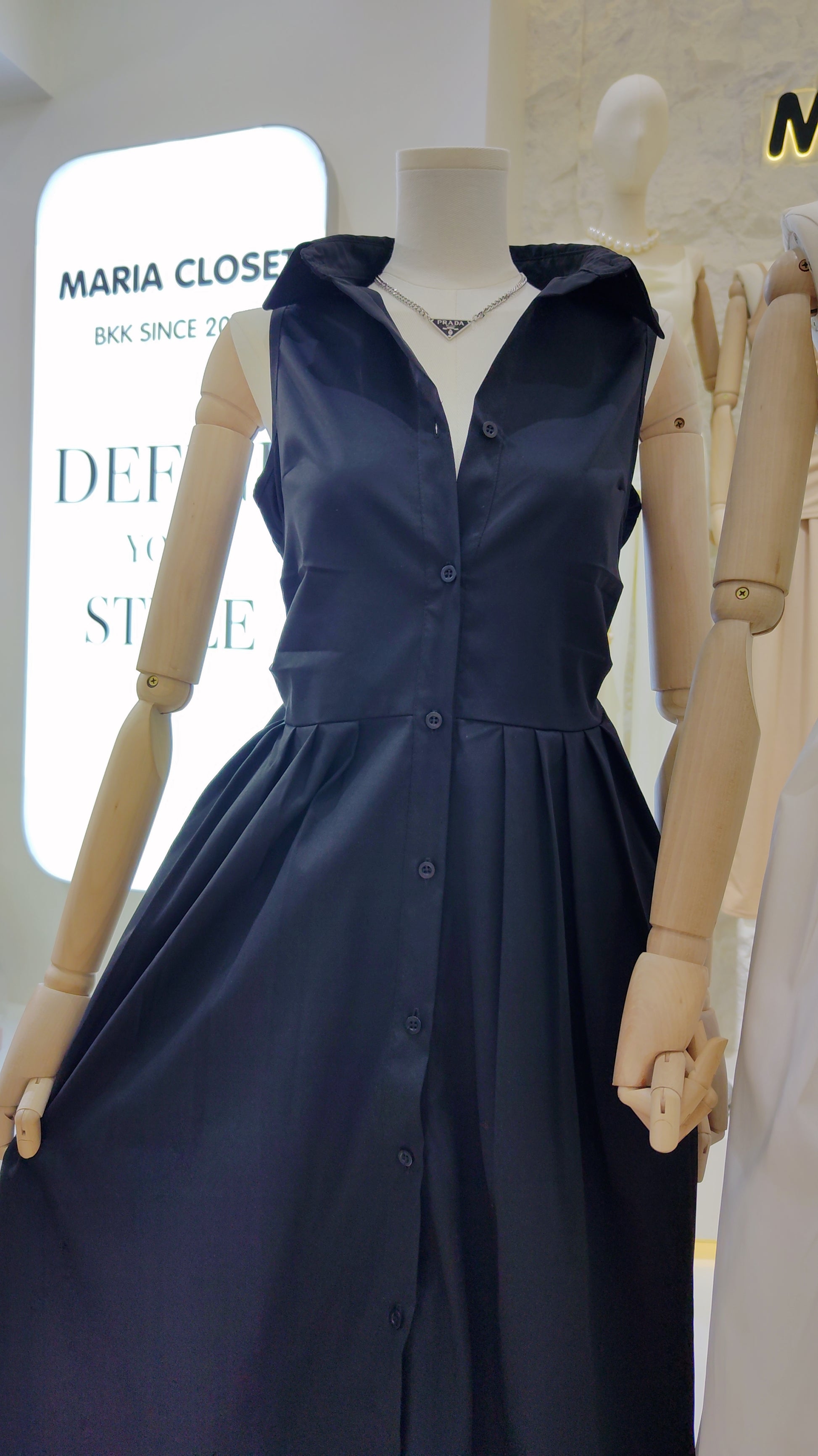 The "Everyday" Sleeveless Shirt Dress in navy with collar and full button front on a mannequin.