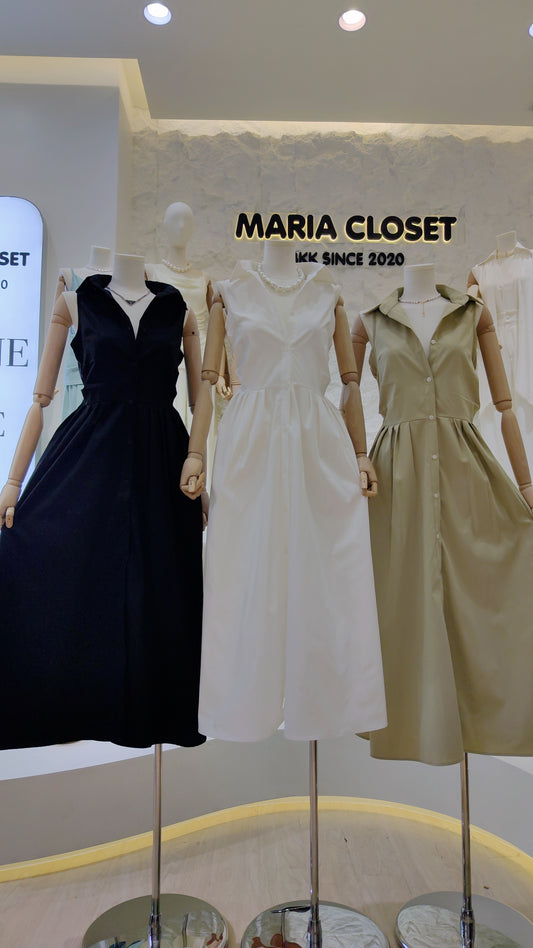 The "Everyday" Sleeveless Shirt Dress in black, white, and beige displayed on mannequins in store.